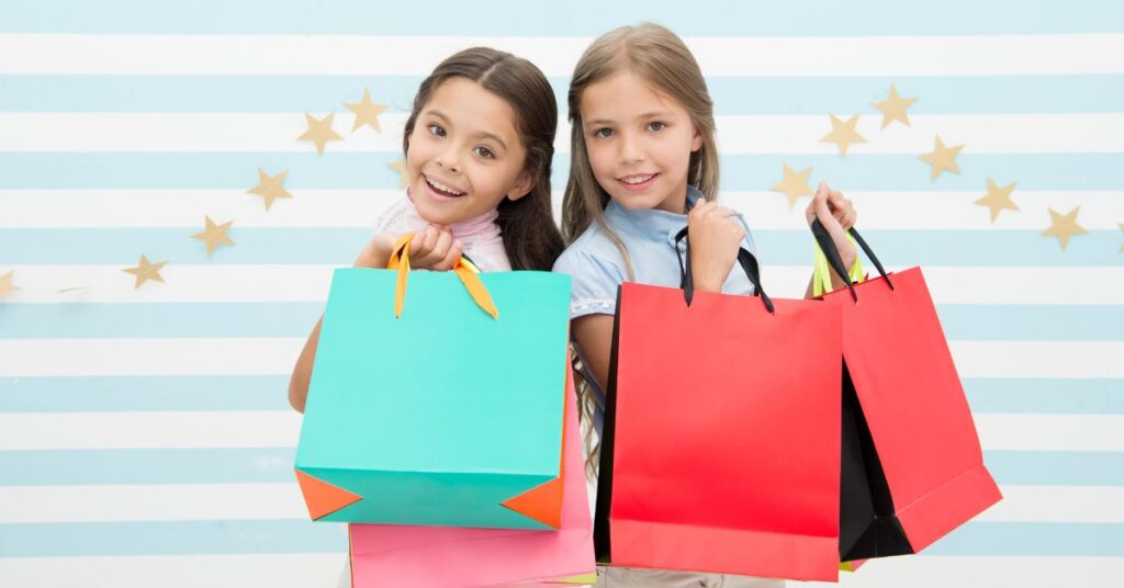 children holding bags of goods