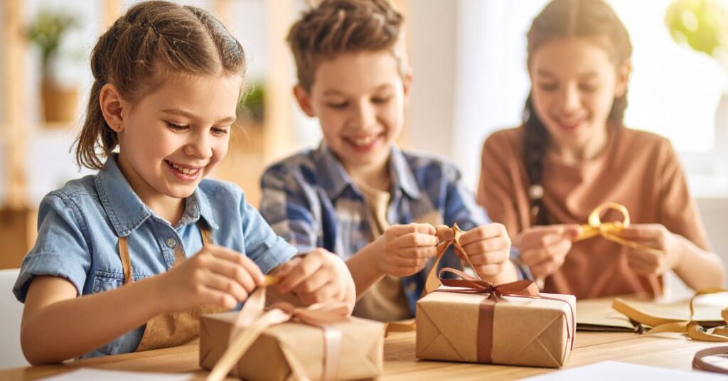 children wrapping gifts, holiday shop ideas for your elementary school