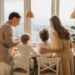 A family enjoying breakfast together in a warm sunlit kitchen, fostering togetherness.