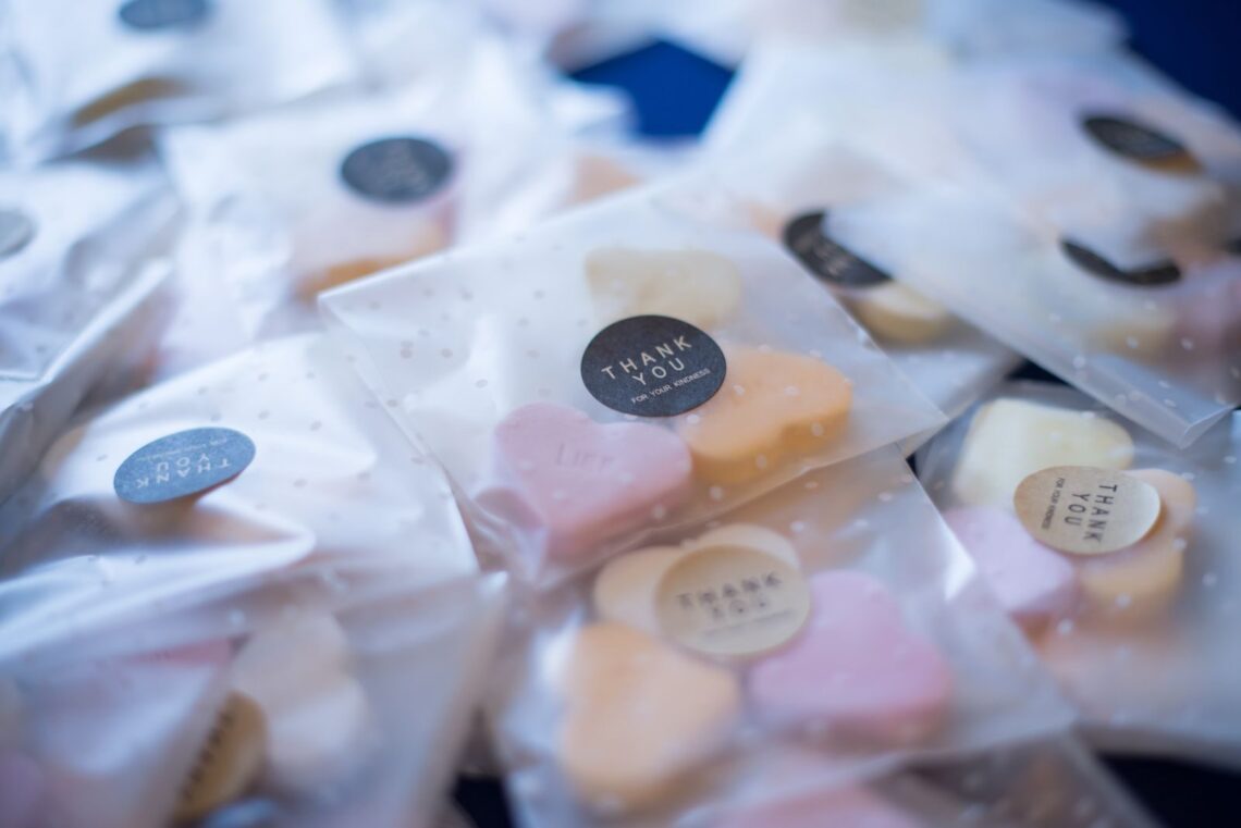 Close-up of heart-shaped candies packaged with personalized thank you labels, ideal for gifts.