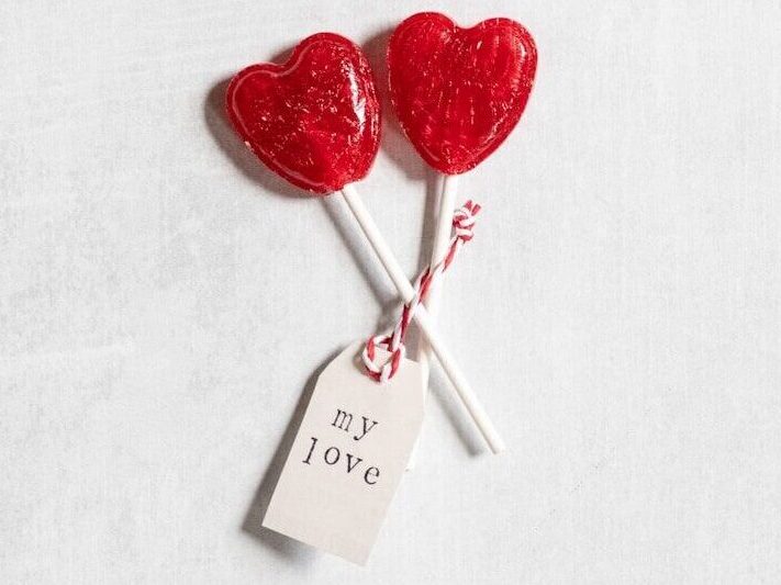 How to Run a Candy Grams Fundraiser at School: A Step-by-Step Guide 3 two heart shaped lollipops on a stick with a price tag