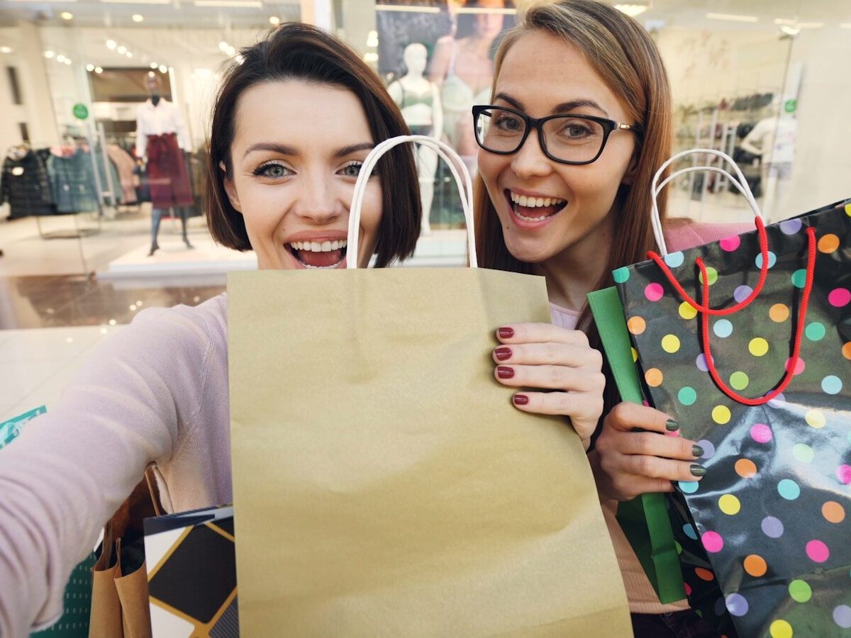 How to Run a Candy Grams Fundraiser at School: A Step-by-Step Guide 5 Two happy women holding shopping bags in a mall.